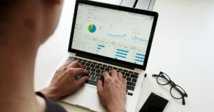 a man watching data trends on a computer