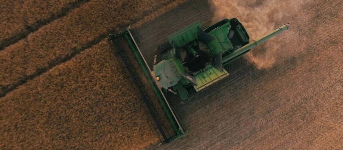 a farmer in a tractor plowing his field