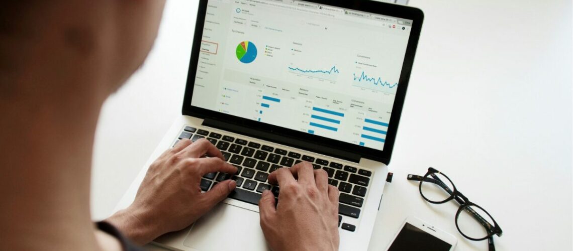 a man watching data trends on a computer