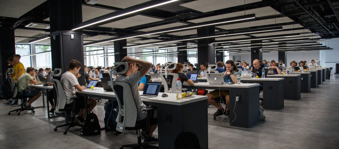 Modern office space filled with people working at their desks
