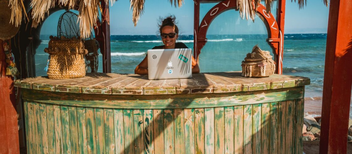digital nomad working from a tiki bar